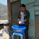 A child domestic worker washes outdoors in Peru