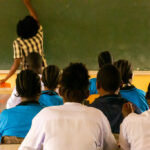 Children in a school in Tanzania facing the blackboard