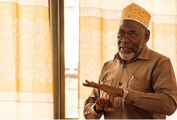 An image of a man speaking at an event