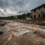 An image of a river rising with flood water