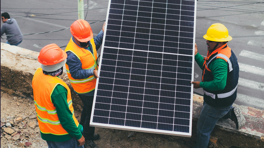 Workers holding solar panels