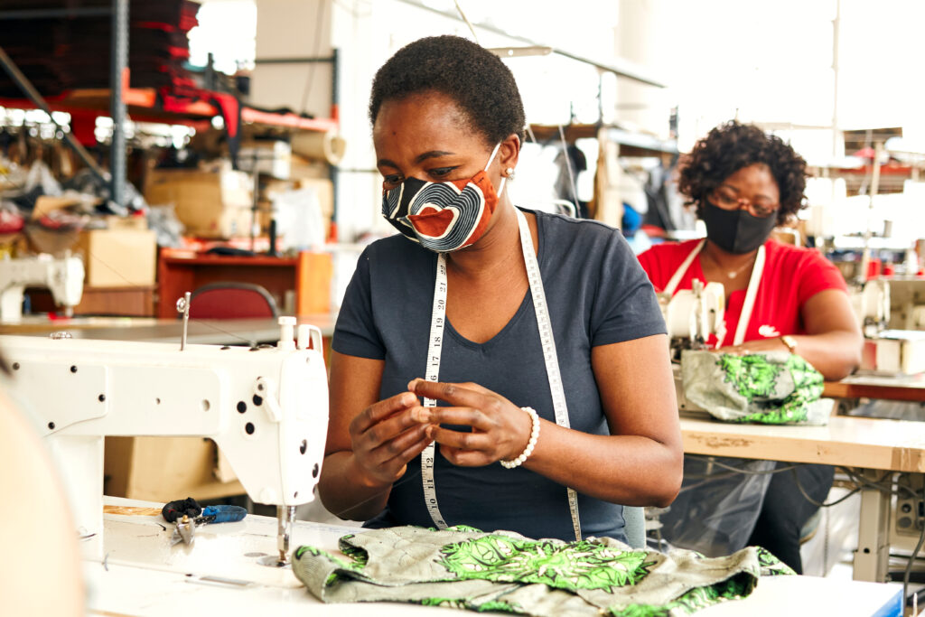 Two women workers in a textile factory with sewing machines