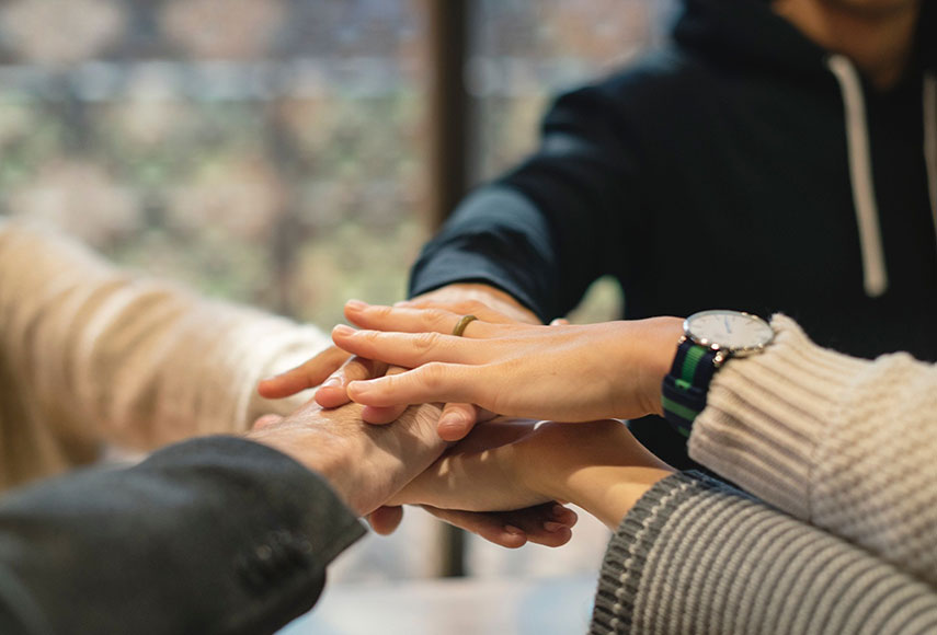 5 people join hands together